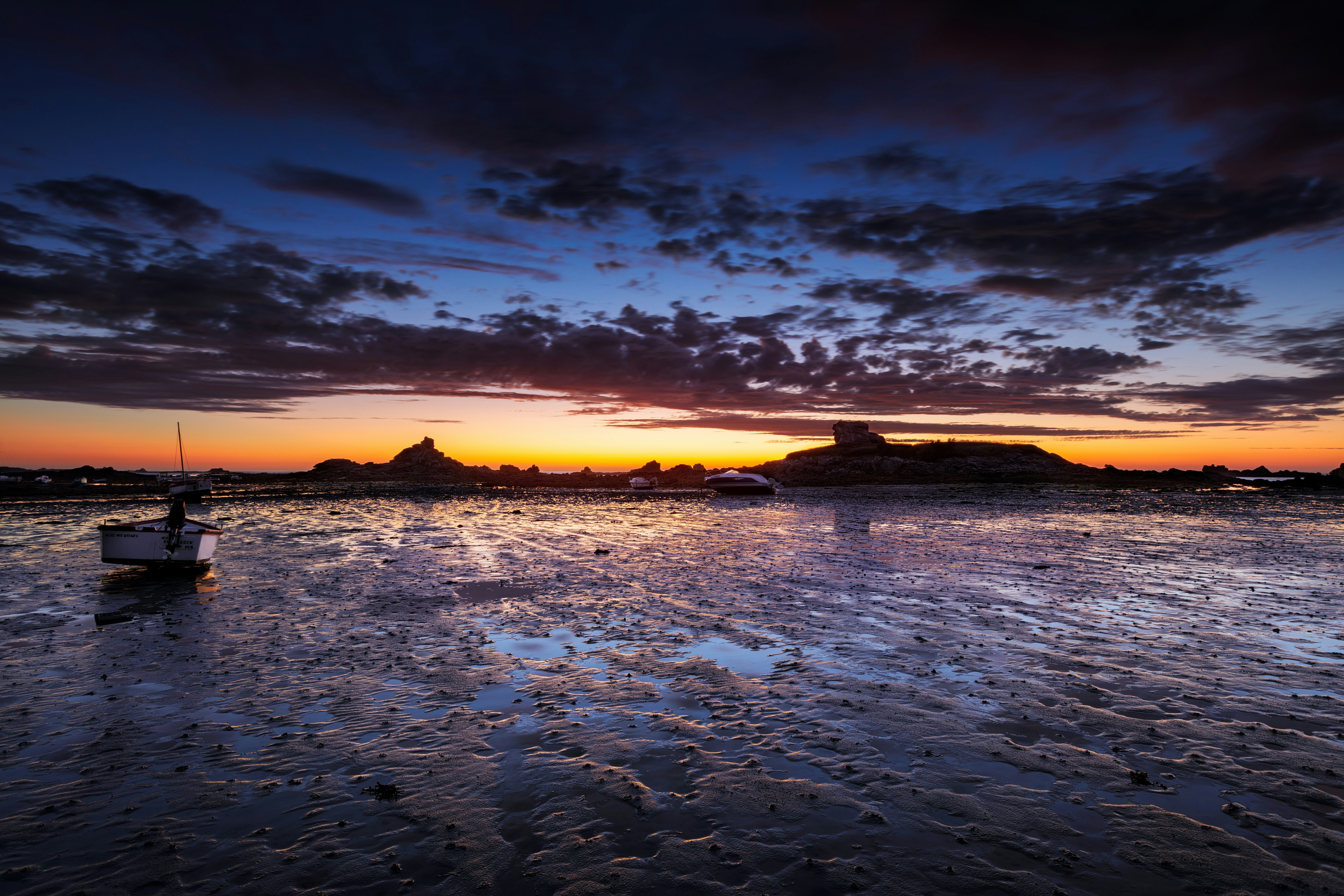 body of water under cloudy sky during sunset